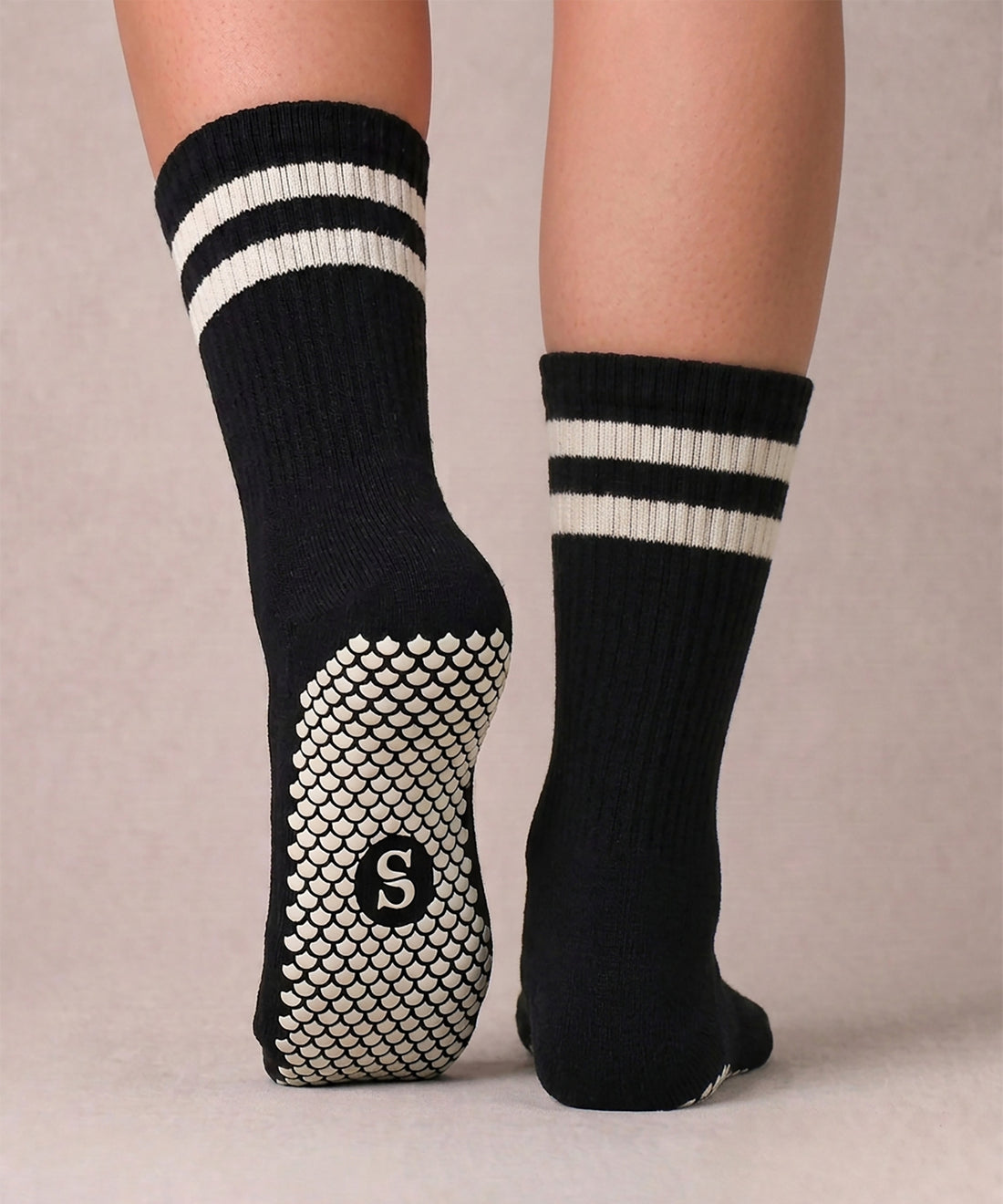 SIREN Crew Grip Socks in Orca, worn on feet. 