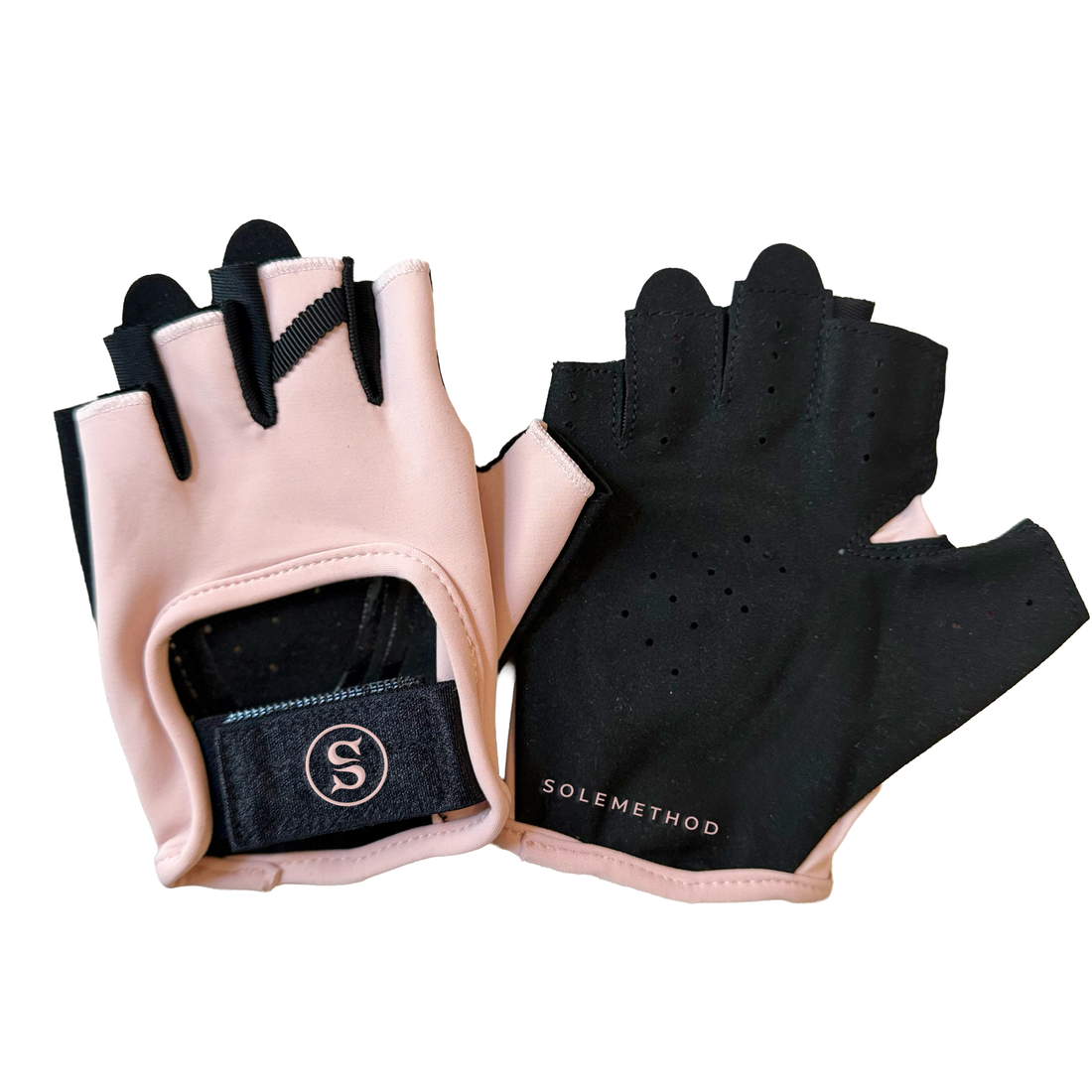 SIREN Grip Gloves in Seashell, a blush-pink fingerless glove with black palm and fingertips and a black wrist strap featuring the circular SOLEMETHOD S logo.