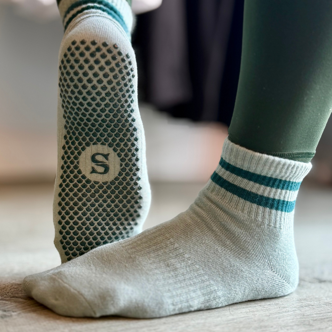 SIREN Seafoam Grip Socks worn on both feet, showing the seafoam green sock and its Mermaid Sole grip.