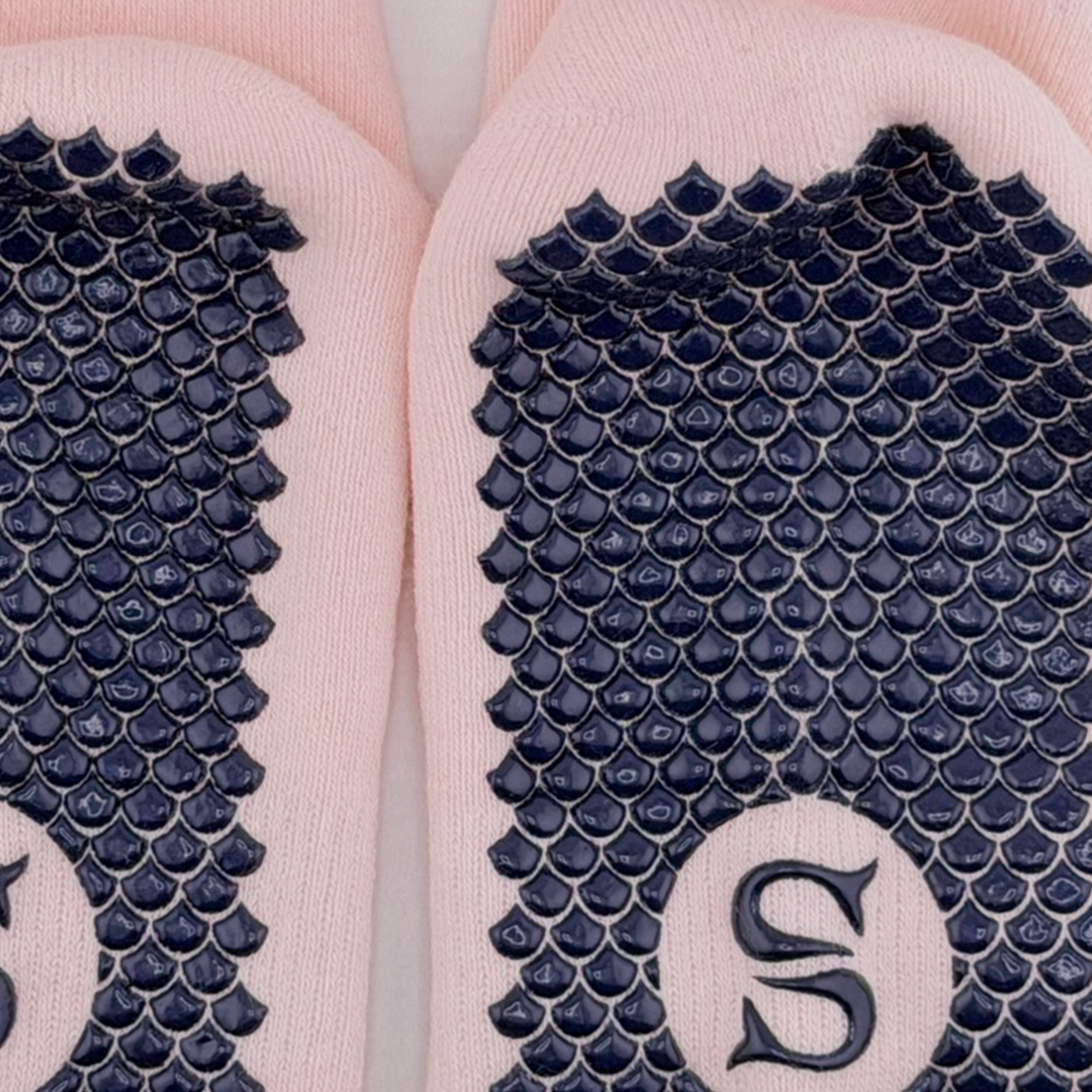 Close-up of the SIREN Warrior Grip Sock in Seashell showing the Mermaid Sole grip and embroidered emblem.