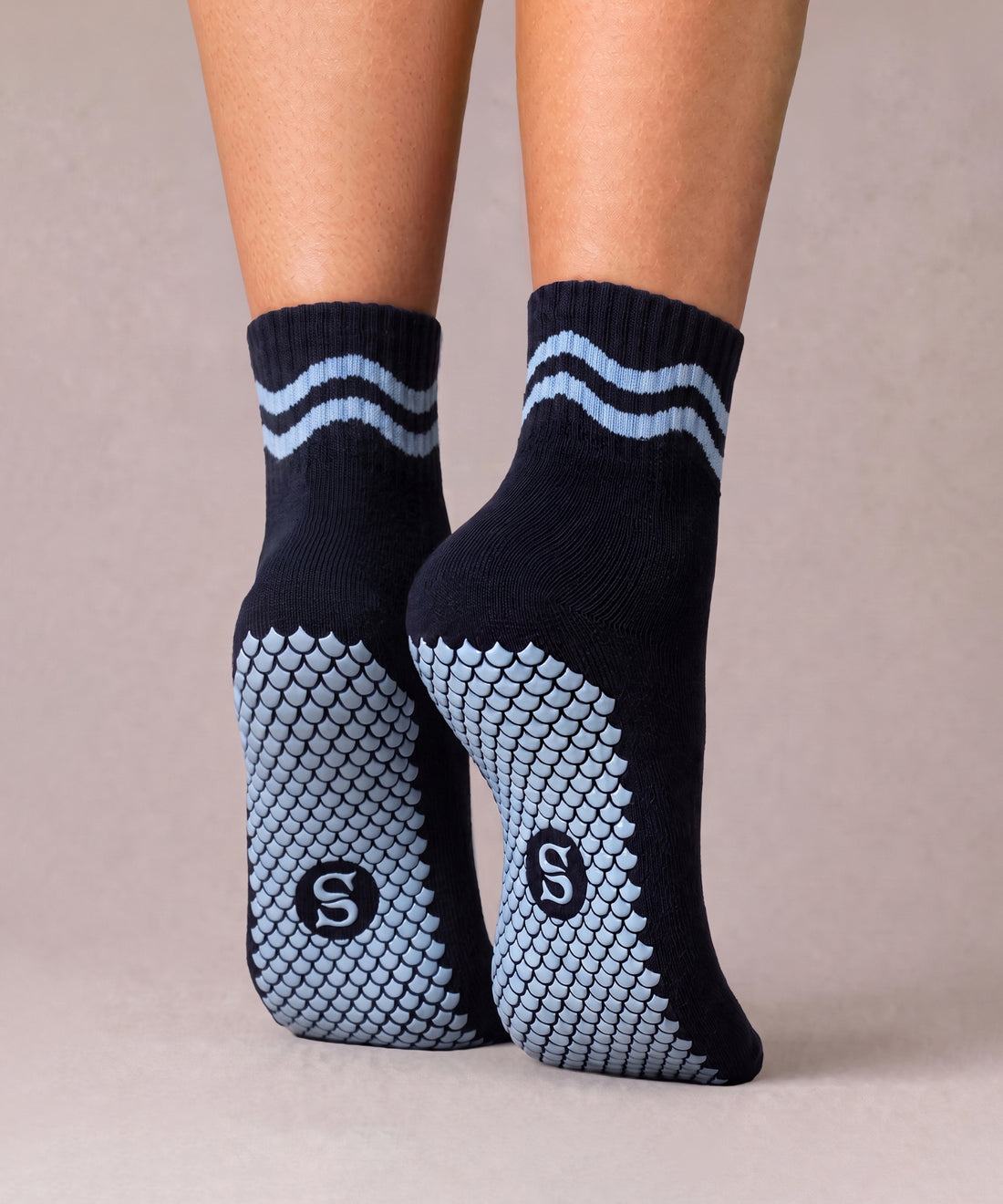 SIREN Wave Mini Crew Grip Socks in Midnight Waves, worn on feet. 